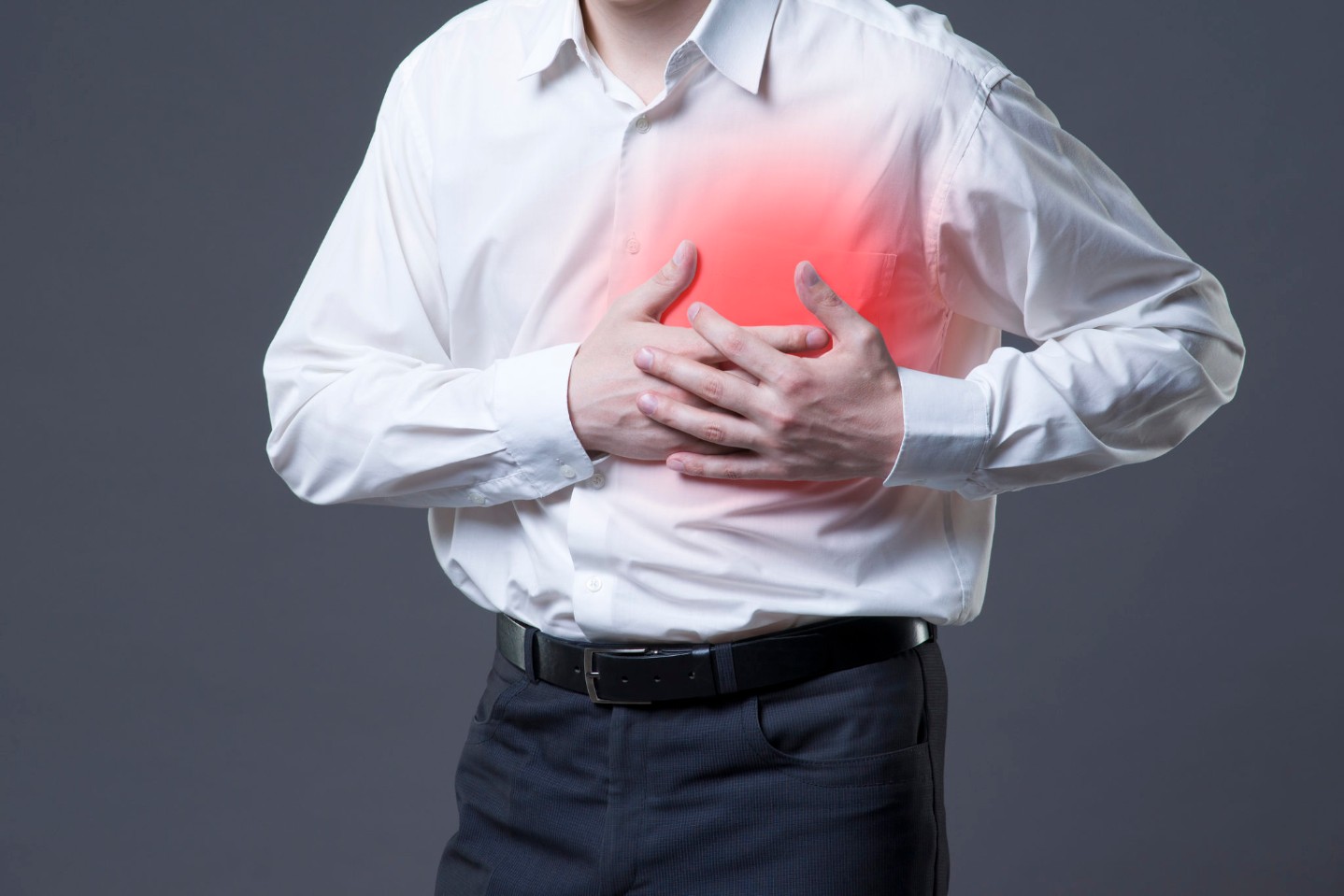Heart attack, man with chest pain on gray background