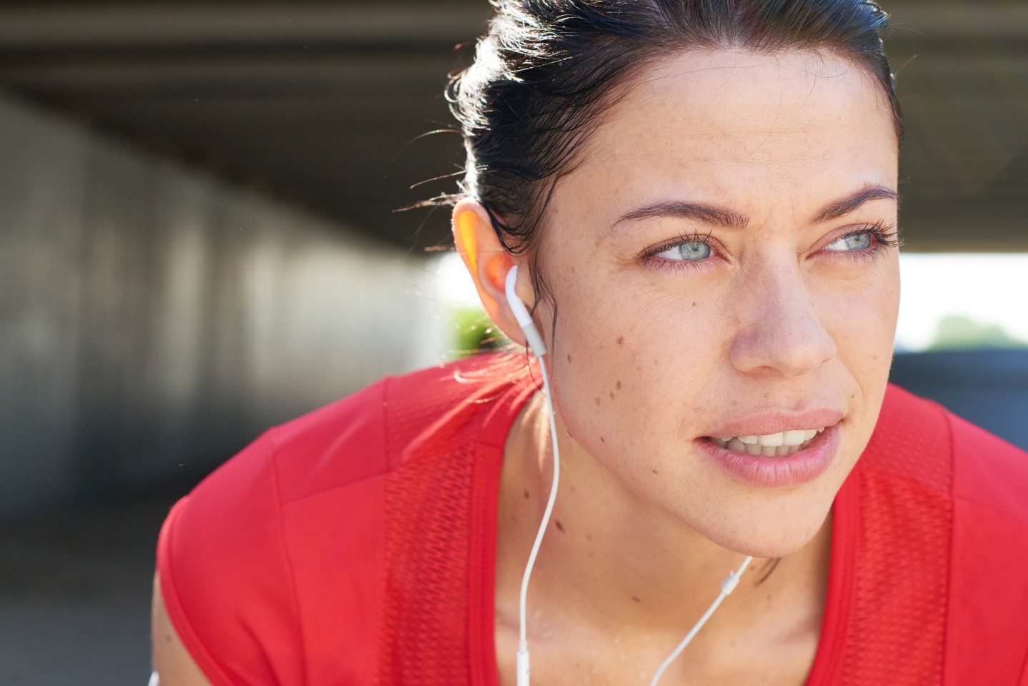 woman in a red shirt resting during a jog