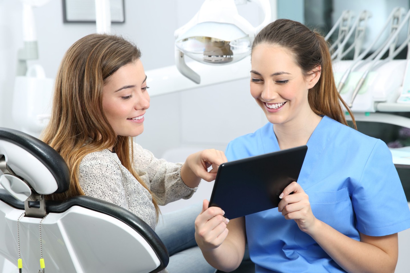 Dentist and patient choosing treatment