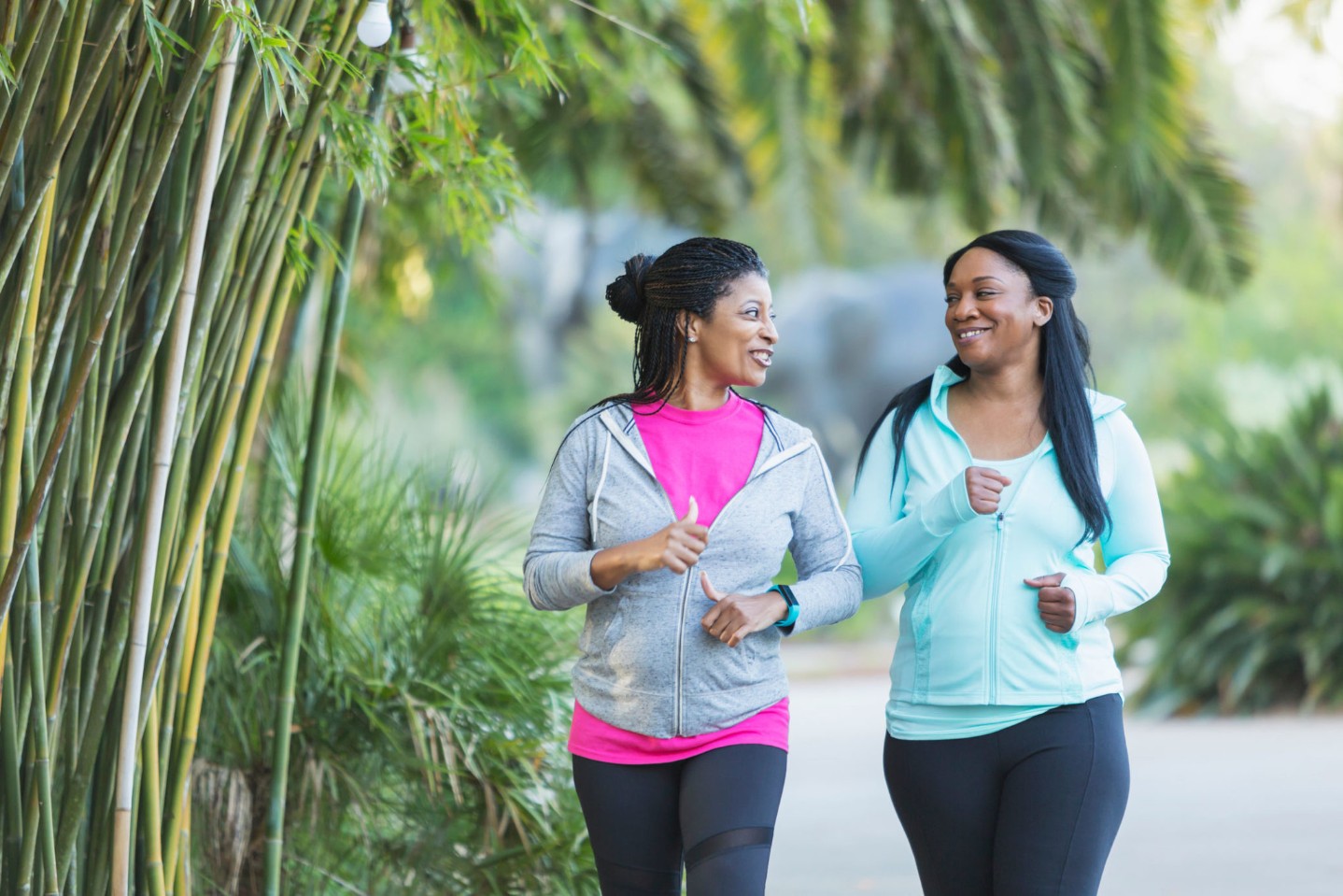 get-out-and-exercise||African American woman and friend running with dumbbells