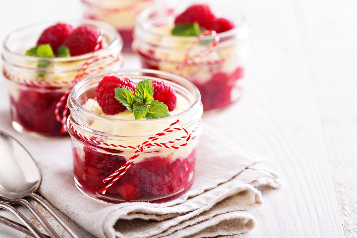 raspberries and cream in mason jars||