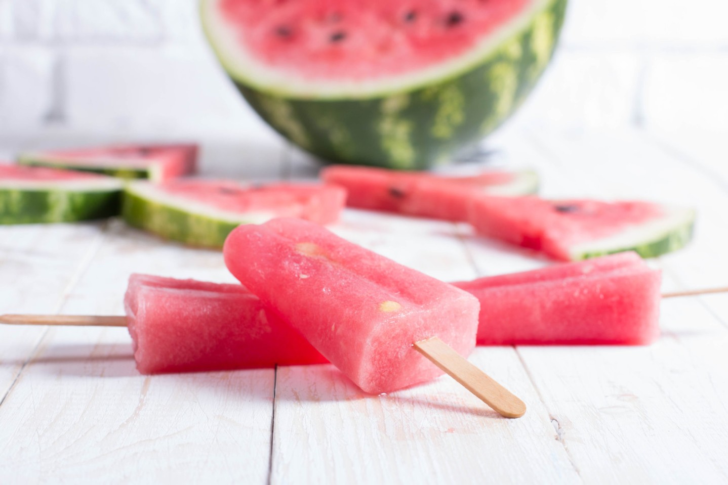 Ice pop of watermelon on a white board. Slices of red watermelon