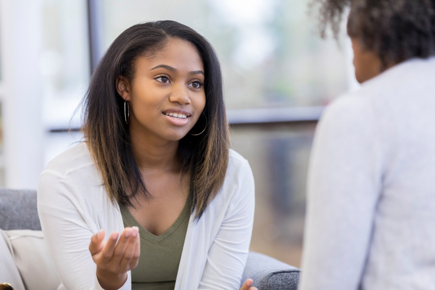 Teenage girl talks with therapist