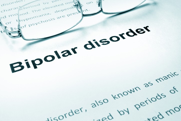 Bipolar disorder sign on a paper and glasses.