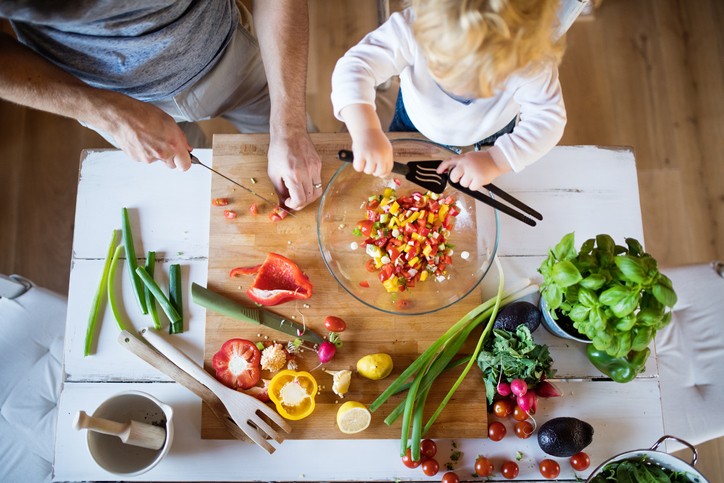 A man with his son making vegetable salad.||woman starting gallbladder diet