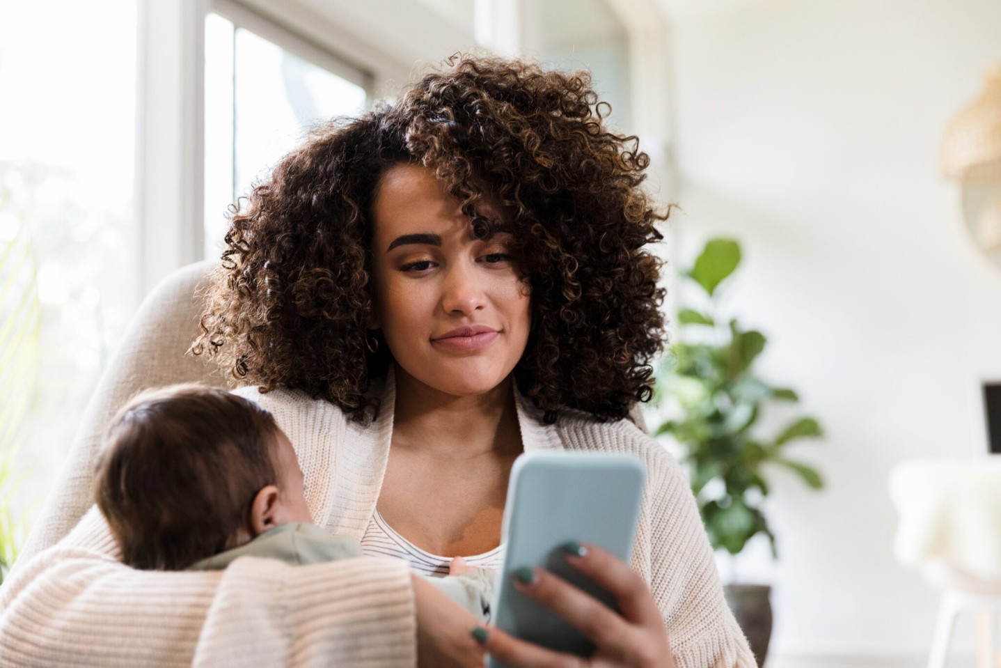 New mom uses smartphone at home