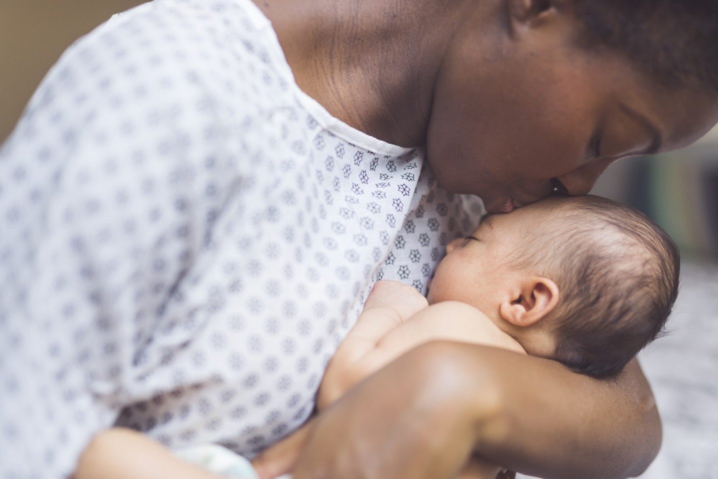 mom holding newborn to chest