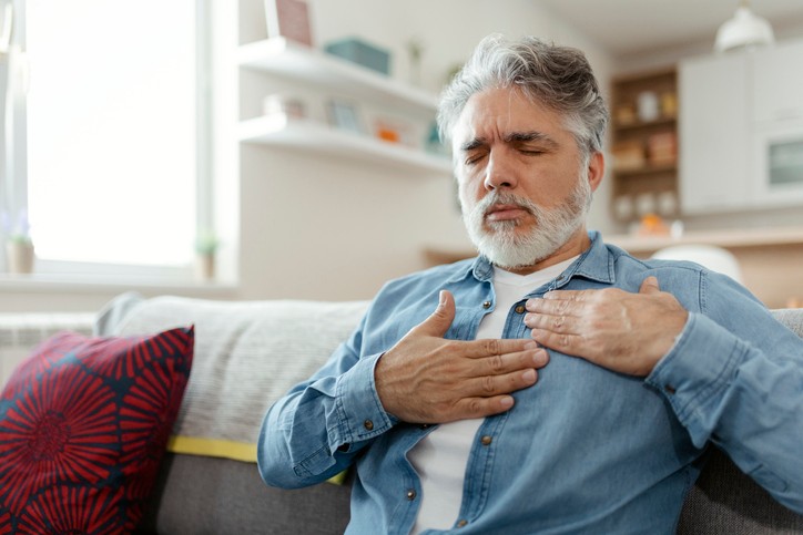 Male suffering from bad pain in his chest heart attack at home - heart disease