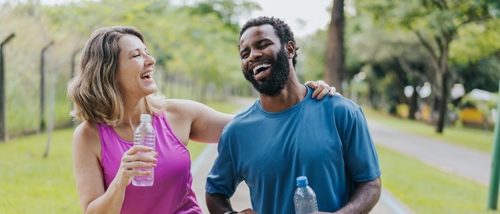 Middle aged man and women exercising together and smiling