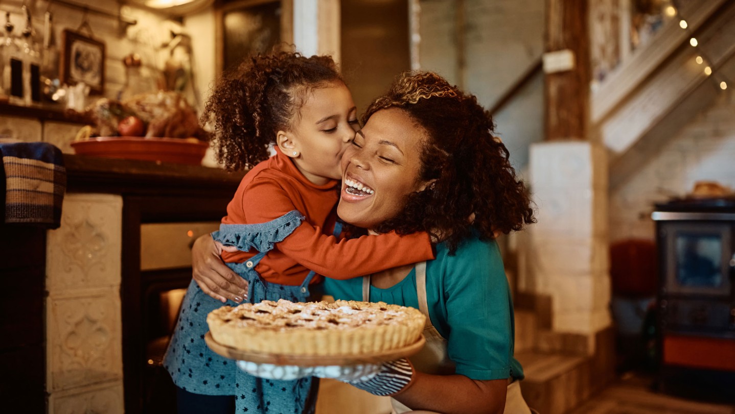 Woman and young girl smiling with their pie