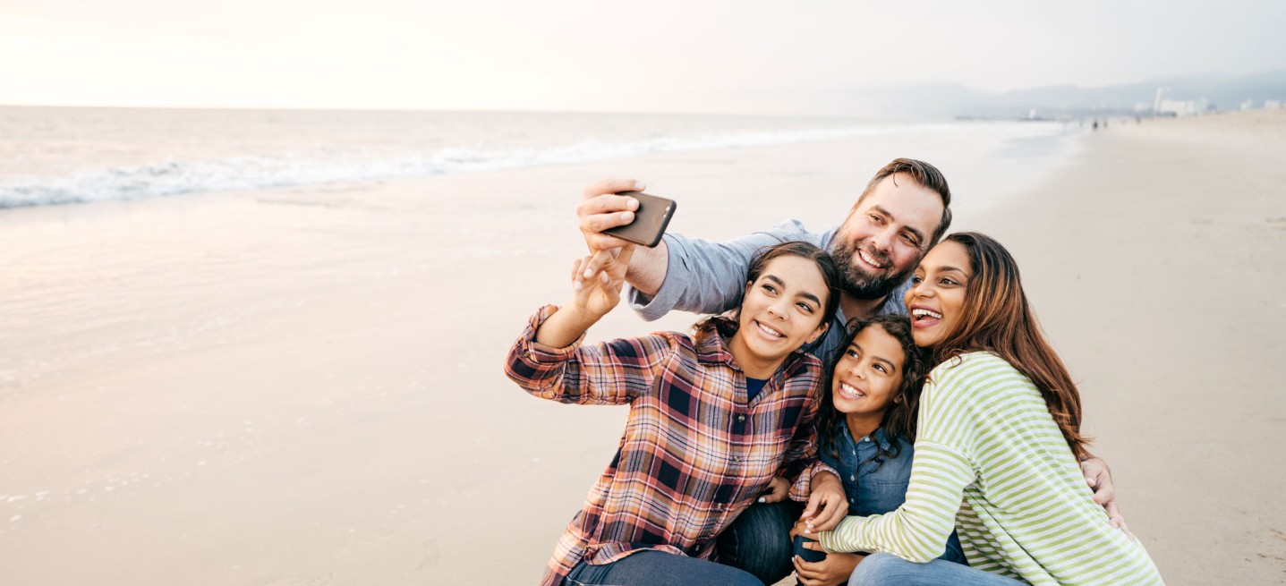 Family taking photo on the beach