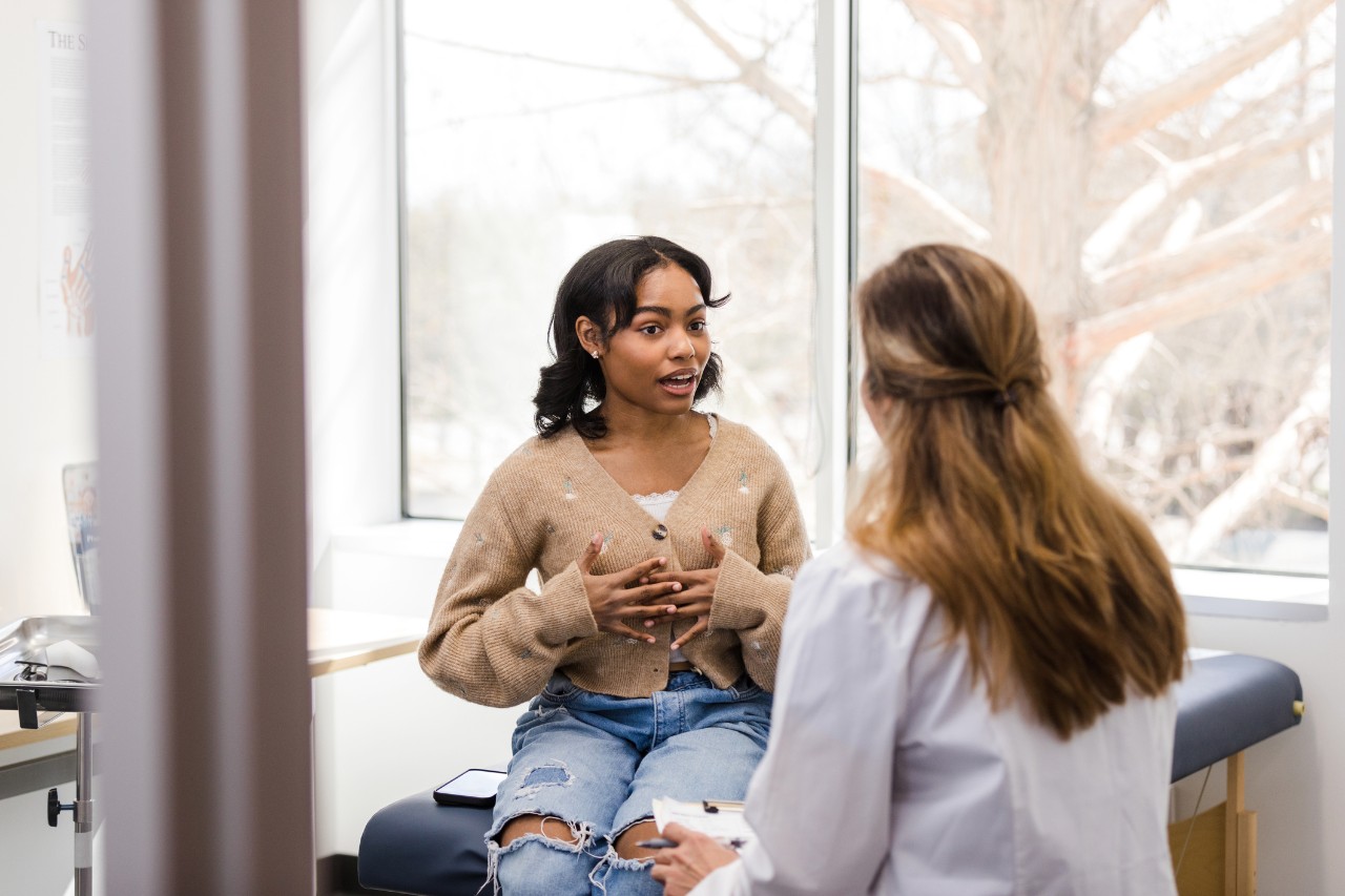 Young woman talking to her doctor in the clinic