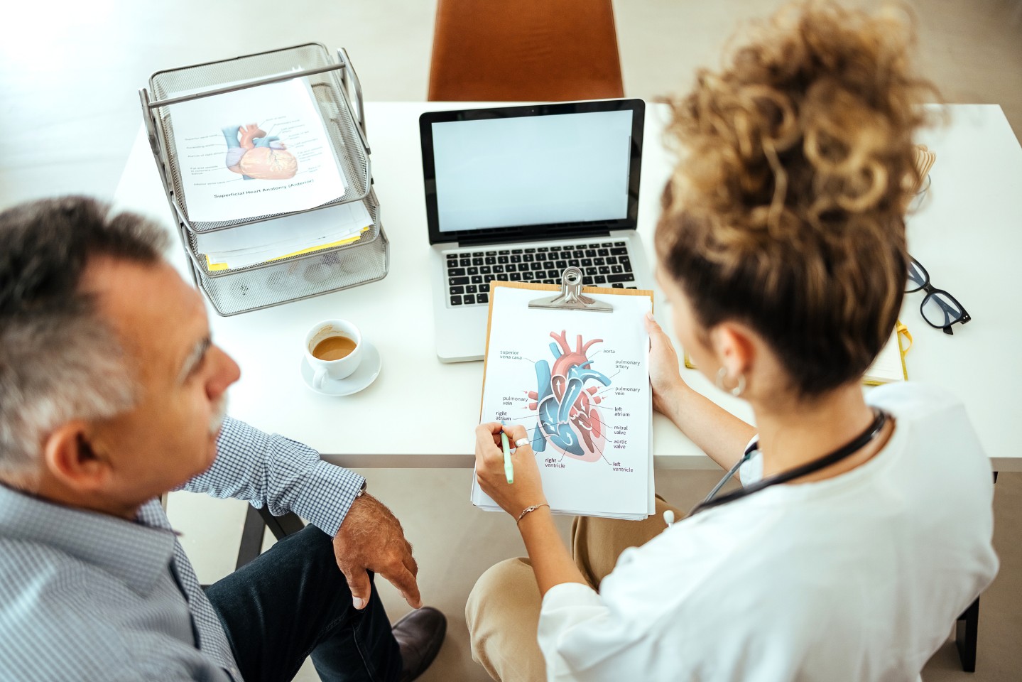 Doctor showing a diagram of the heart valves to a patient