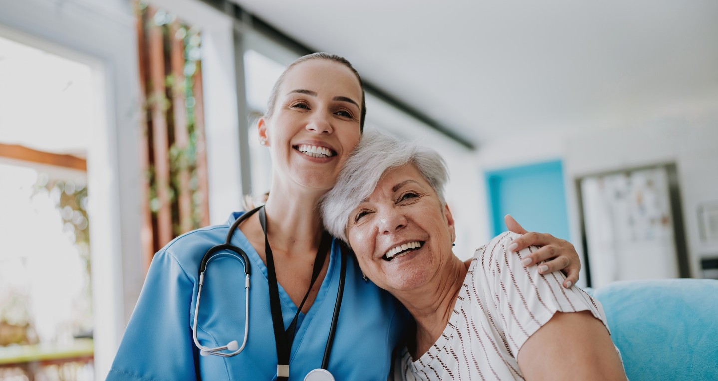 Elderly woman patient smiling with her nurse
