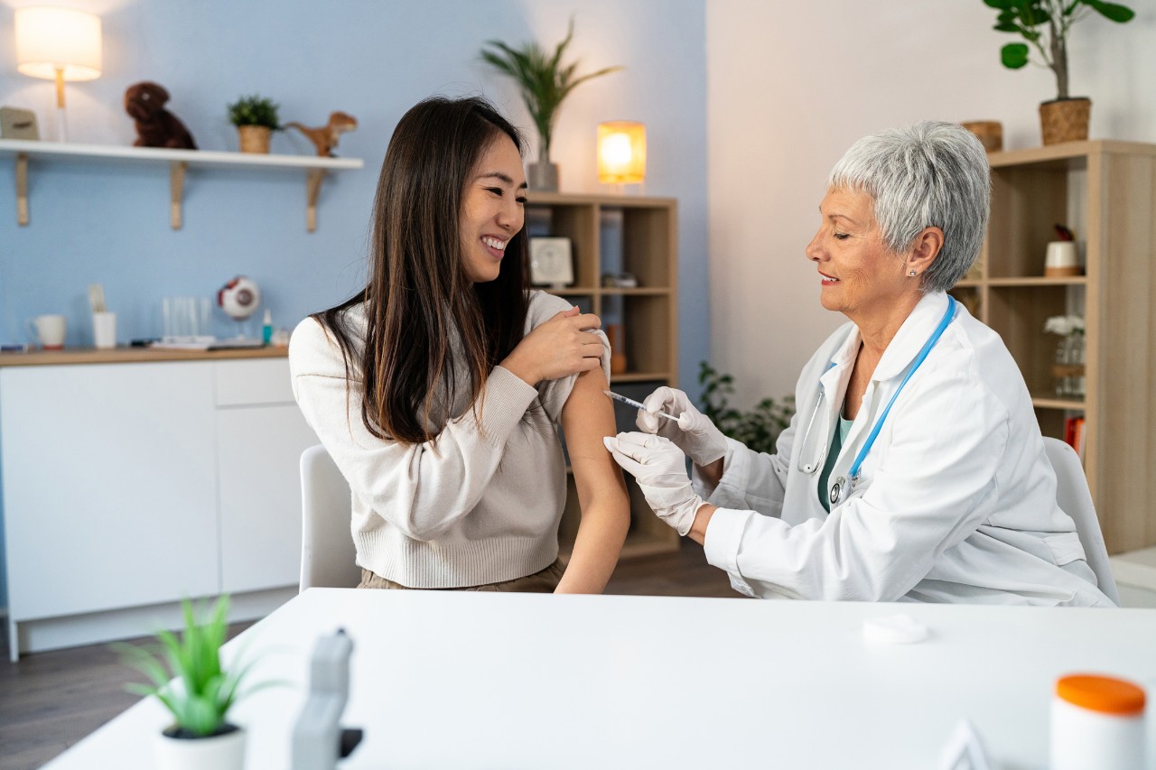 Asian American woman getting her flu vaccination