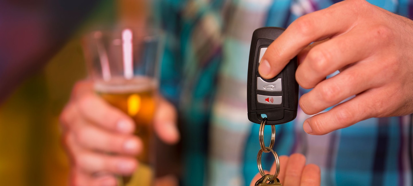 Person handing over car keys 