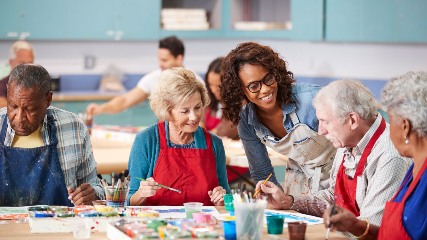 Group of older adults painting together 